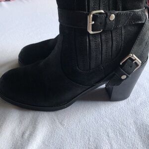 Woman’s black heeled booties